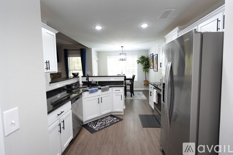 A modern kitchen with white cabinets and a large island.