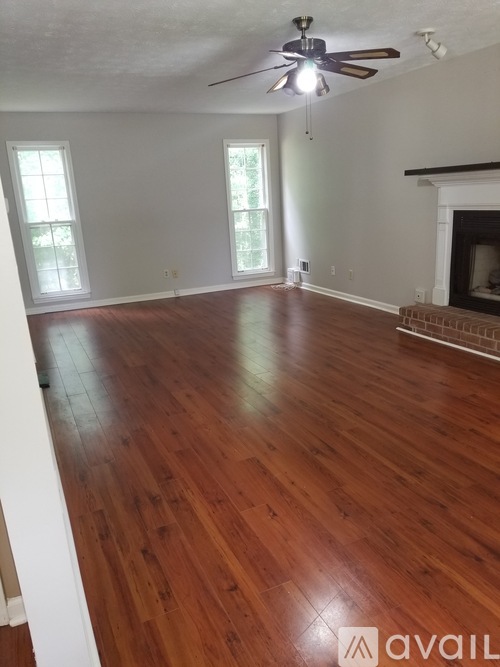A room with wooden floors and a fireplace.