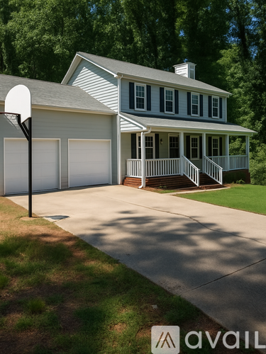 A house with a grey roof and white walls with a basketball hoop in front.