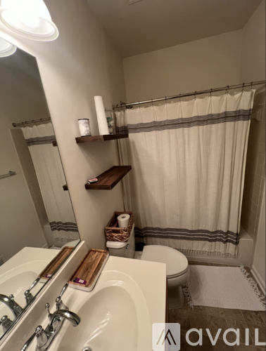 A bathroom with a white sink and a white toilet.