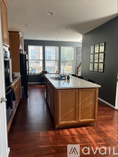 A kitchen with wooden cabinets and a large island.