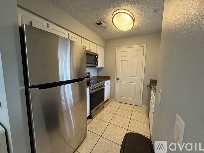 A kitchen with a stainless steel refrigerator, microwave, and dishwasher.