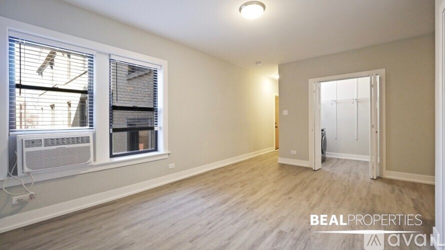 A spacious room with a window and a door is on the market.