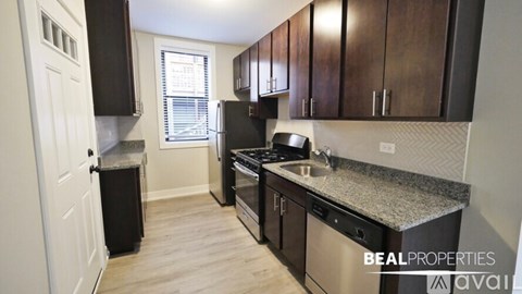 A kitchen with dark wood cabinets and stainless steel appliances.