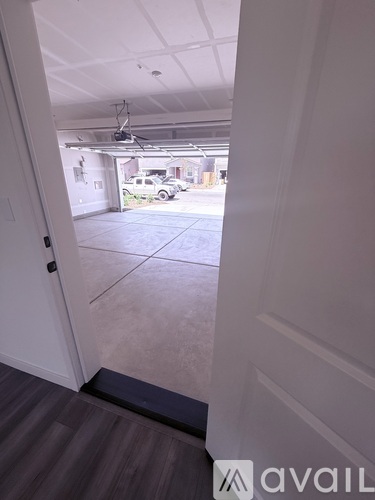 A view from inside a building looking out to a parking lot.