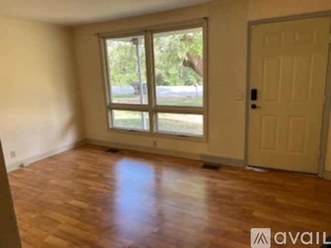 A room with wooden floors and a white door.