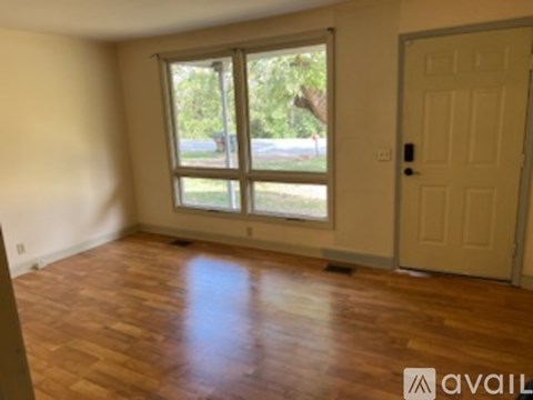 A room with wooden floors and a white door.