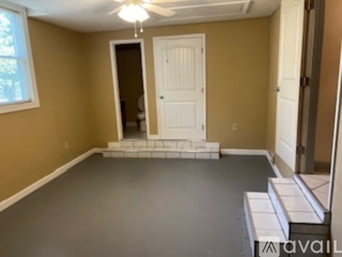 A room with a white door and a window.