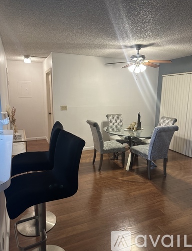 A dining room with a table set for four.
