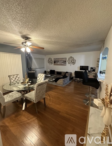 A living room with a dining table and chairs.