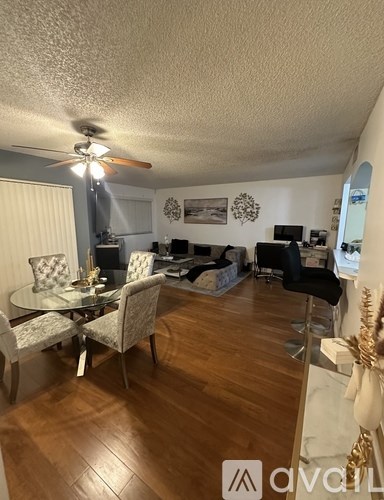 A living room with a dining table and chairs.