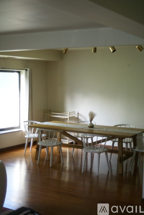 A dining room with a table and chairs.