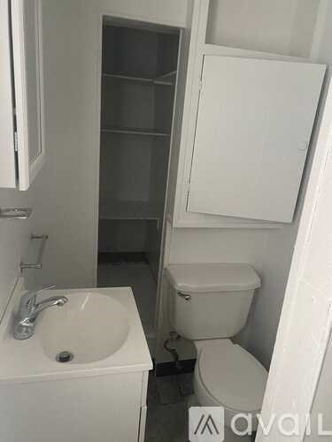 A white sink and toilet in a small bathroom.