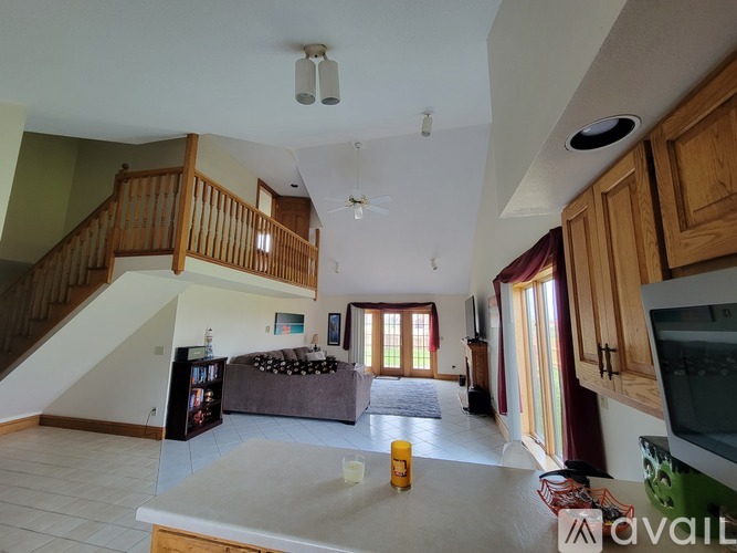 A living room with a staircase and a couch.