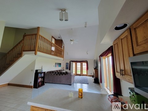 A living room with a staircase and a couch.