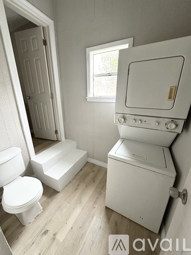 A white toilet and sink in a bathroom.
