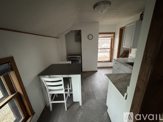 A kitchen with a table and chairs in the middle of the room.