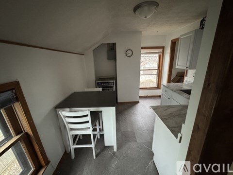 A kitchen with a table and chairs in the middle of the room.