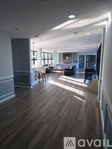 A spacious living room with wooden floors and furniture.
