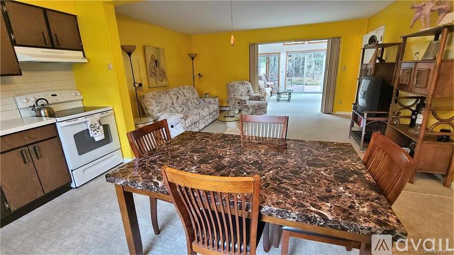 A kitchen with a table and chairs in the middle of the room.