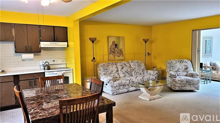 A kitchen with yellow walls and a table with chairs.