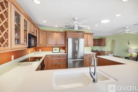 A kitchen with wooden cabinets and a white countertop.