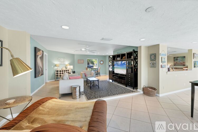 A living room with a brown couch and a television.