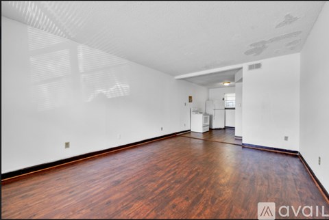 A room with wooden floors and white walls.