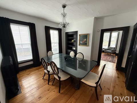 A dining room with a glass table and chairs.