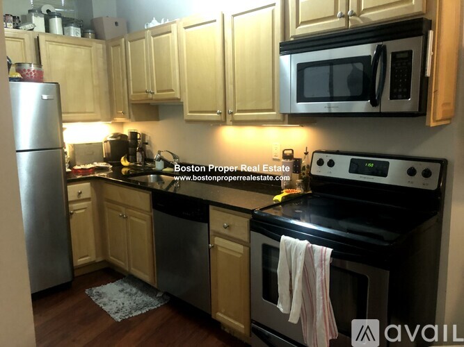 A kitchen with wooden cabinets and a black stove top.