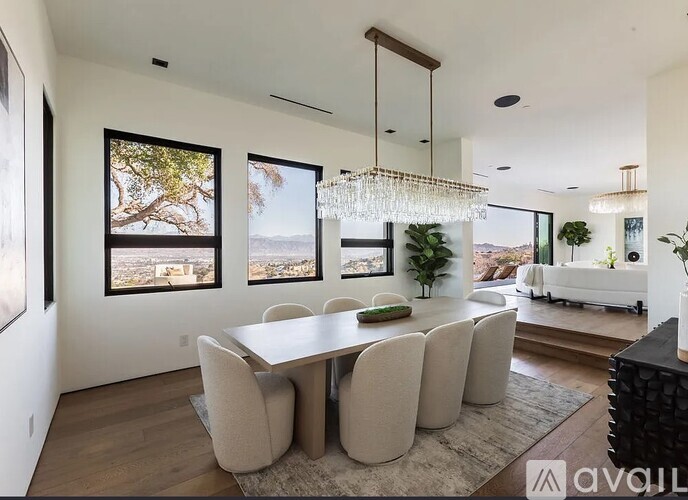 A modern dining room with a large table and chairs.