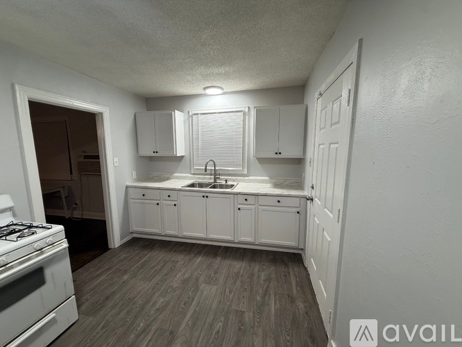A kitchen with white cabinets and a gas stove.