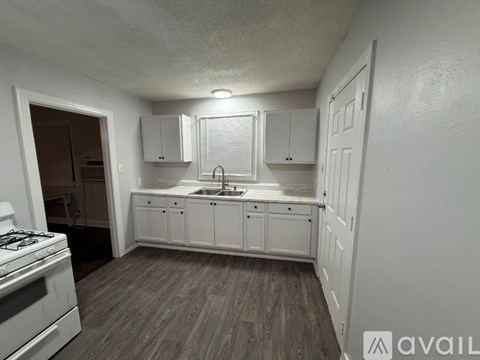 A kitchen with white cabinets and a gas stove.