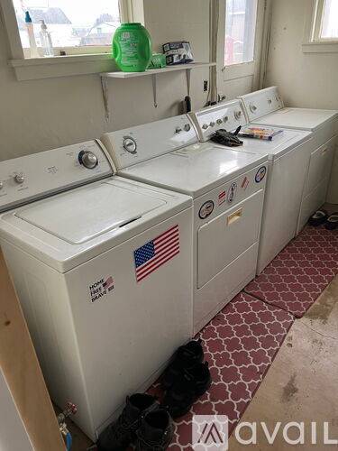 A row of washing machines with an American flag sticker on the front.