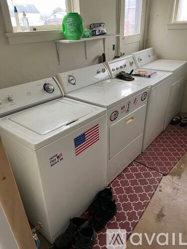 A row of washing machines with an American flag sticker on the front.