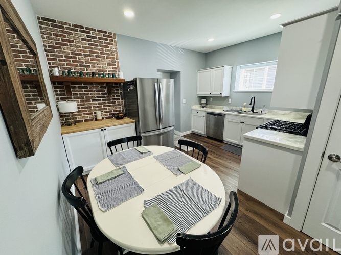 A kitchen with a table set for four.
