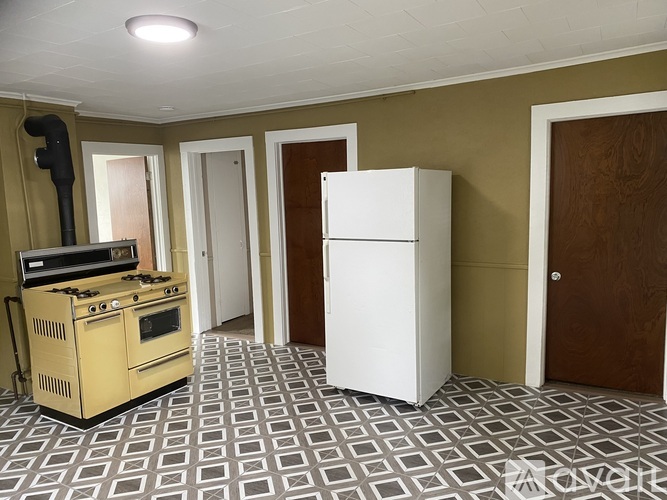 A kitchen with a stove, oven, and refrigerator.