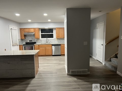 A kitchen with wooden cabinets and a white countertop.