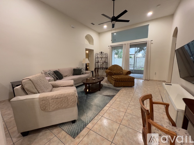 A living room with a couch, armchair, and coffee table.