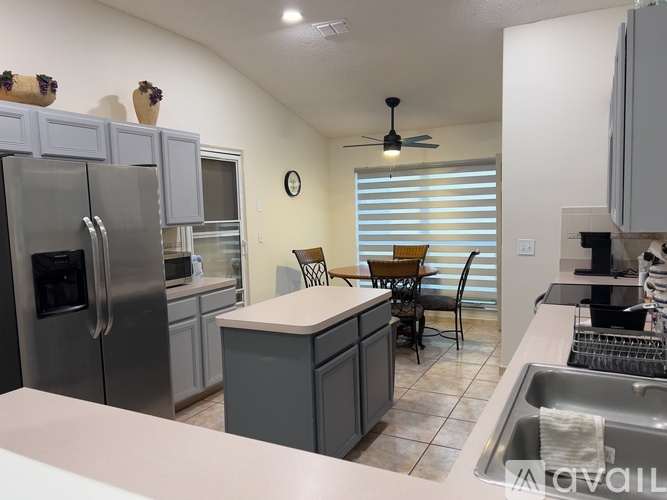 A kitchen with a table and chairs in the middle of the room.