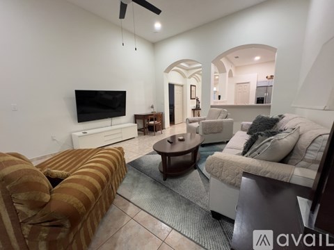 A living room with a striped sofa and a television.