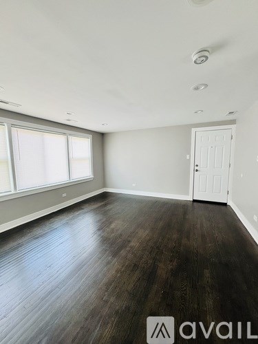 A room with wooden floors and a white door.