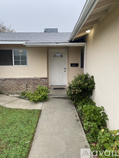 A house with a white door and a small front yard.
