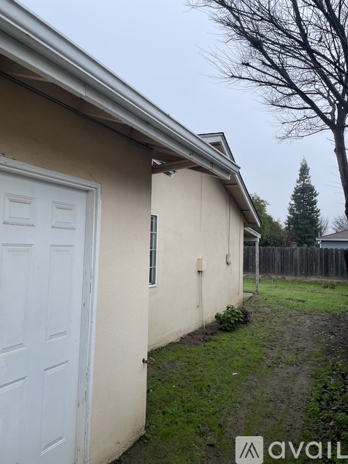 A small house with a white door is shown in the image.