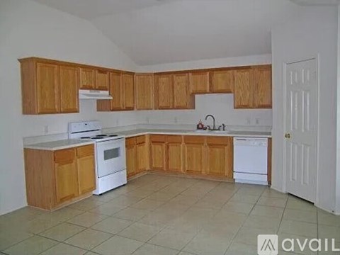 A kitchen with wooden cabinets and white appliances.
