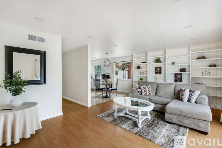A living room with a grey couch and a coffee table.