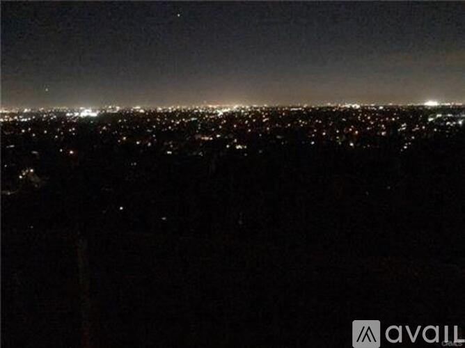 A cityscape at night with numerous lights.
