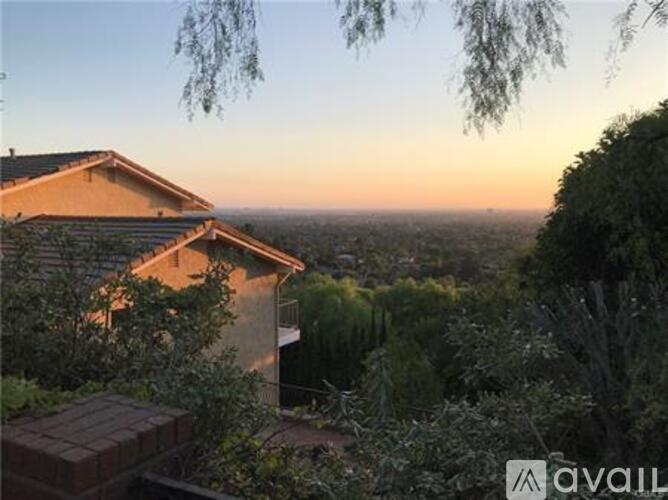 A house with a view of the city at sunset.