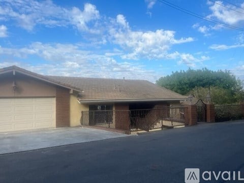 A house with a brown roof and a white garage door.
