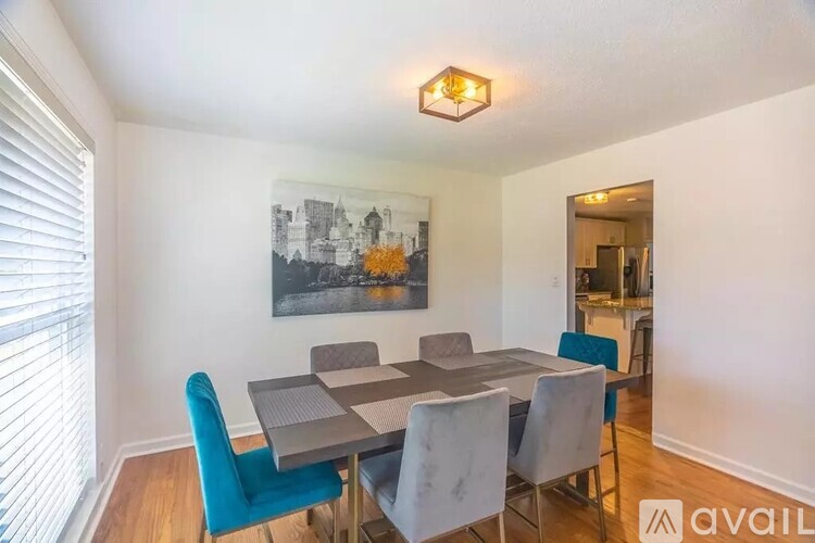 A dining room with a table and chairs.